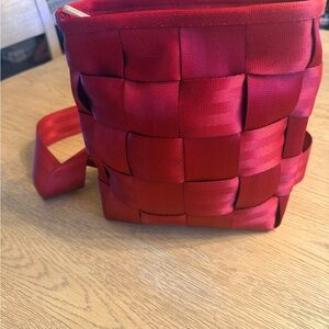 Women’s Red Harvey’s Crossbody Seatbelt Bag. 10”h x 9”w